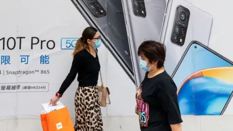 Getty Images The Xiaomi 10T Pro advert wiht two women in front.