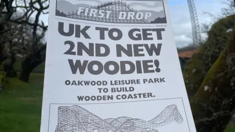 La portada delantera de la revista PRIMERSA publicada en el momento en que se estaba construyendo megafobia. ¡El titular dice el Reino Unido para obtener el segundo nuevo Woodie! Oakwood Leisure Park para construir una montaña rusa de madera '. A continuación se muestra un bosquejo en blanco y negro de la megafobia. 