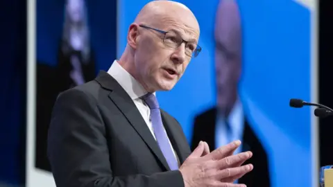 PA Media John Swinney delivering a speech on the 10th anniversary of the independence referendum