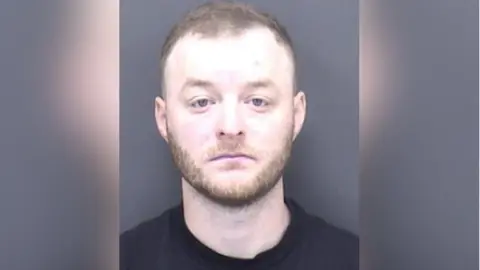 Connor O'Brien's mugshot. He wear a black shirt.