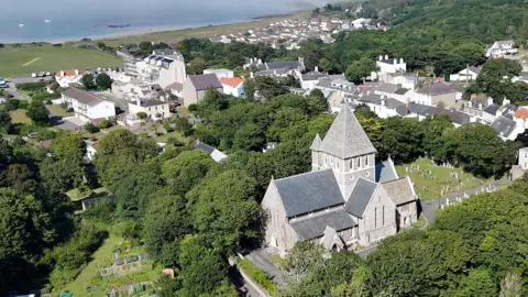 BBC An aerial picture of the church showing its large size and surrounding area. The sea is visible in the background. 