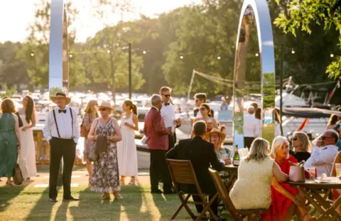 Garry Jones Henley Festival crowd beside the River Thames.