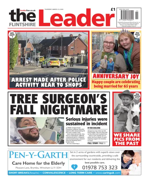 The Flintshire Leader The Flintshire Leader front page with a leading article, the headline for which reads: "Tree surgeon's fall nightmare". The picture is of a man in a hospital. Above is a photo of police cars on a residential road with the headline 'arrest made after police activity near to shops'. A smaller box contains a picture of an elderly couple with the headline 'Anniversary joy: Happy couple are celebrating being married for 65 years'. A black and white image of a boy riding a horse sits below, with the headline 'we share pics from the past'