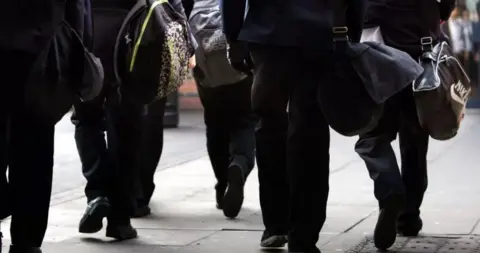 PA Media Anonymous children at school