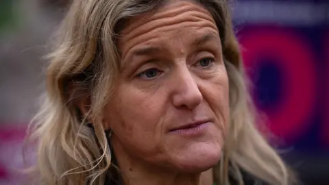 Spen Valley MP Kim Leadbeater, who has long blonde hair and blue eyes. She has a neutral expression in the photo.