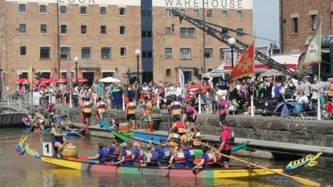 BBC Image of crowds on Gloucester Docks watching the dragon boat race