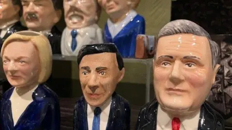 BBC Toby Jugs on a shelf in the Parliament shop depicting Liz Truss, Rishi Sunak and Sir Keir Starmer