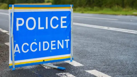 generic image of a blue, white and yellow road sign which reads 'POLICE ACCIDENT'
