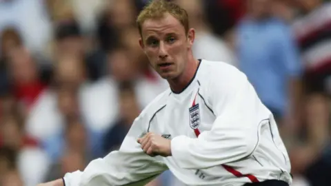 Getty Images Nicky Butt, wearing an England shirt