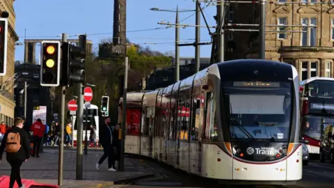 Getty Images A tram in front of the Balmoral Hotel in Edinburgh on a sunny day.
