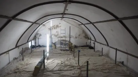 Ben Edwards Interior roof of church where lots of damp is seen on the walls.