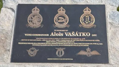 Gary Hadden/@garyh_creates A memorial for Czech pilot Alois Vasatko. The memorial is made from stone and has a plaque on the top of it.