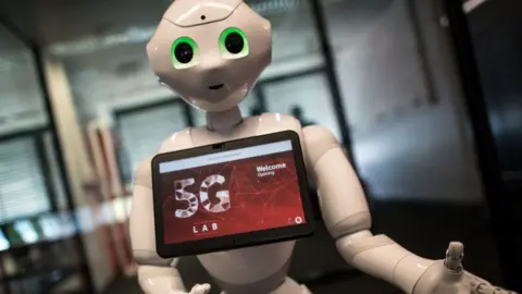 Getty Images Pepper robot with screen advertising 5G logo