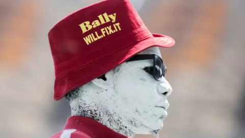 Getty Images A supporter of newly-elected Zambian President Hakainde Hichilema watches proceedings at the inauguration ceremony in Lusaka.