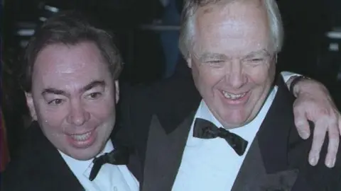 PA Media A close up image of Andrew Lloyd-Webber and Tim Rice both wearing dinner suits and bow ties and smiling