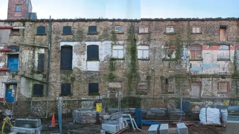 Wakefild Civic Society A dilapidated looking building with building blocks and railings out the front
