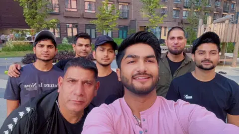 A group of discharged men on a tour of Moscow while they waited to fly home to India -- with Raja Pathan (front), a former recruit who helped them negotiate their way out.