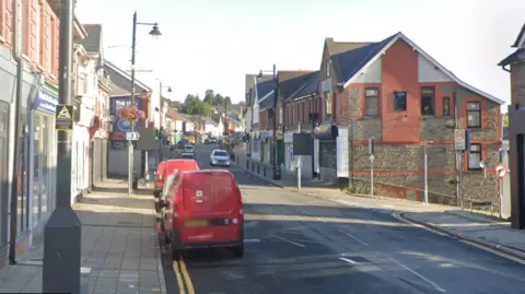 Google Street view of Blackwood high street, two red royal mail vans are parked on the left hand side of the road. 