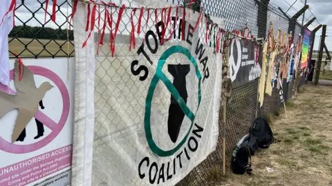 Jon Ironmonger/BBC Signs outside a military base in Lakenheath