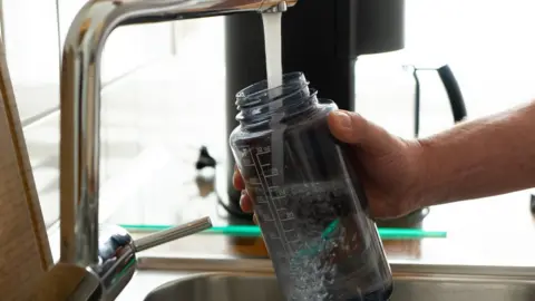 Getty Images Water bottle being filled up