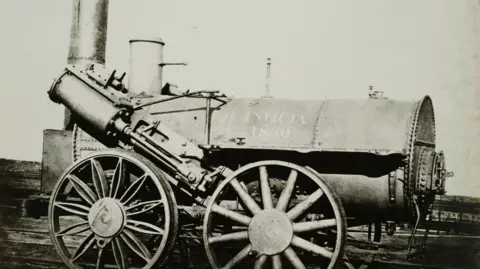 Science & Society Picture Library A black and white photo of a steam locomotion with the words Invicta 1830 written on it 