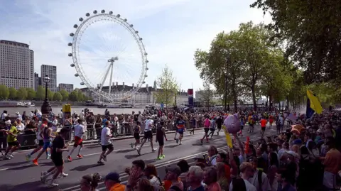 London Marathon runners with the London Eye in the background