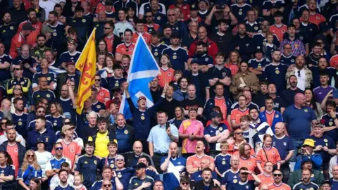 PA Media A crowd of football fans wearing Scotland tops in a stadium