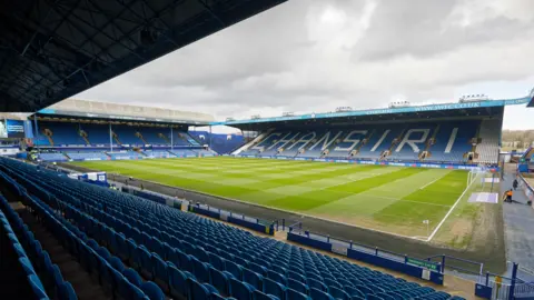 Getty Images Hillsborough stadium from one of the stands with blue chairs surrounding the pitch