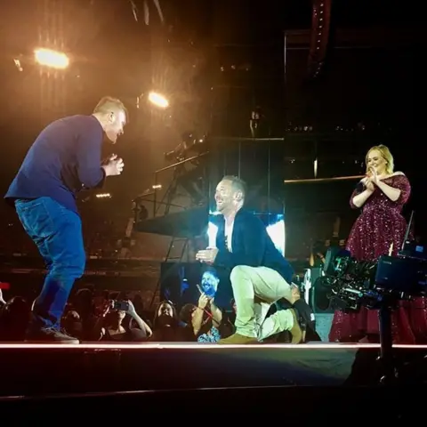Wade Nicholson-Doyle Wade Nicholson-Doyle proposes to his partner Chris as the singer Adele watches on
