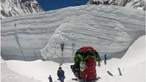 Getty Images Mountaineers close to Camp 2 prepare to ascend steep ladders towards Camp 3