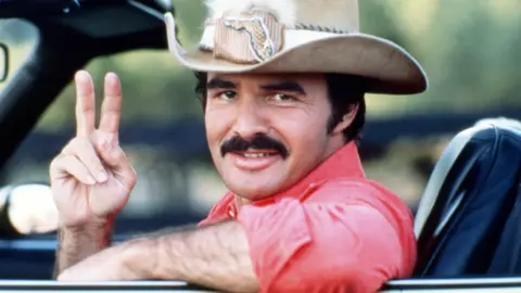 Getty Images American actor Burt Reynolds as Bo 'Bandit' Darville, in 'Smokey And The Bandit', 1977.