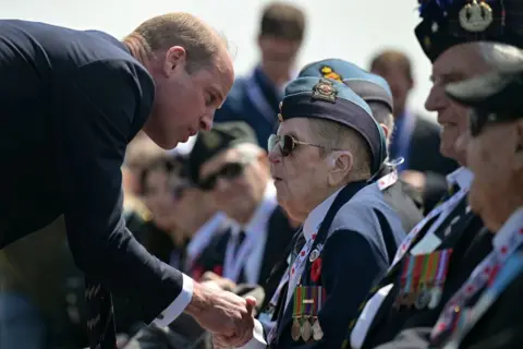LOU BENOIST/EPA Britain's Prince William, the Prince of Wales, speaks with WWII veterans during the Canadian commemorative ceremony marking the 80th anniversary of the World War II 'D-Day' Allied landings in Normandy, at the Juno Beach Centre near the village of Courseulles-sur-Mer, in north western France, 06 June 2024.