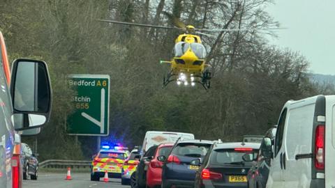 Air ambulance lands on the A6 which is closed by police
