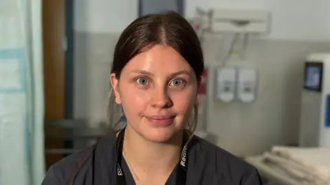 A photo of Alex the sonographer in a hospital room. 
