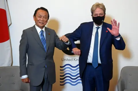 Reuters Japan's Finance Minister Taro Aso and European Commissioner for Economy Paolo Gentiloni pose together at a meeting of finance ministers from across the G7 in London, Britain June 4, 2021