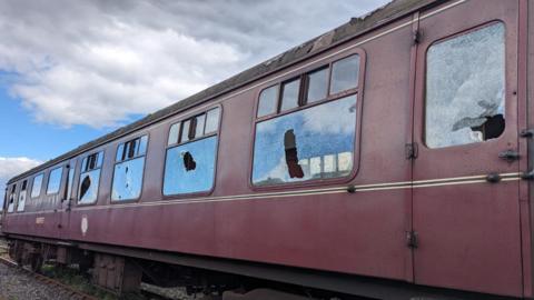 Several smashed windows in rain carriage