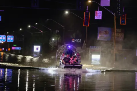  Luis Santana/Tampa Bay Times/ZUMA Press Wire/REX/Shutterstock An airboat transports residents rescued from flood waters due to storm surge in Crystal River
