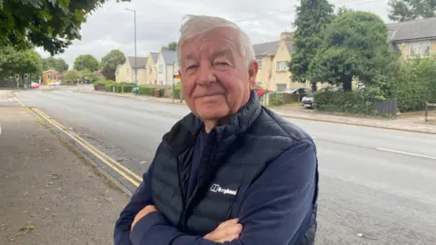 Dave Scott pictured next to a road in Basford