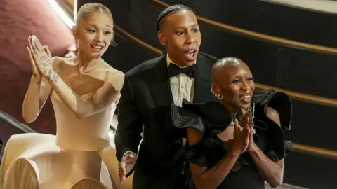 ALLISON DINNER/EPA-EFE/REX/Shutterstock Ariana Grande, Lena Waithe, and Cynthia Erivo react to Nathan Crowley and Lee Sandales winning the Oscar for Best Production Design 