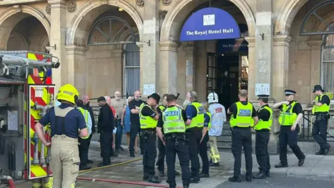 Paul Lead/BBC Fire and police crews gather outside The Royal Hotel
