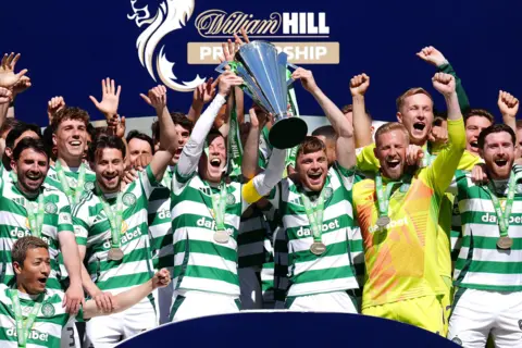PA Media Celtic lifted the Scottish Premiership trophy after the 1-1 draw against St Mirren
