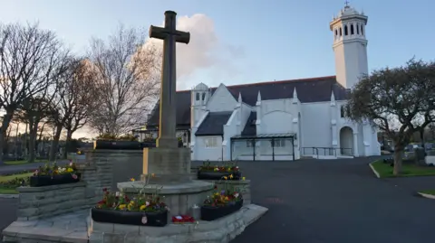 Michael Josem A cross memorial outside a white church