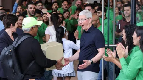 Francis Mascarenhas / Reuters Apple CEO Tim Cook reacts