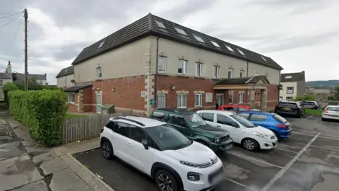 A Google Street View screenshot of the outside of Wyndham Manor care home.