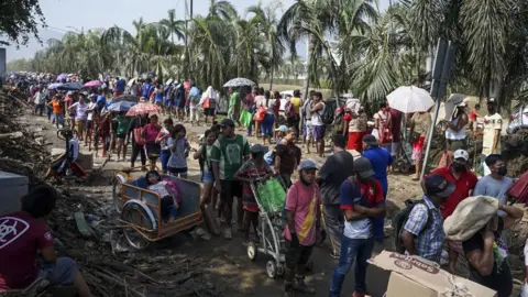 Getty Images A group of people wait to receive food due to the shortage after Hurricane Otis in Guerrero, Mexico on October 29, 2023.
