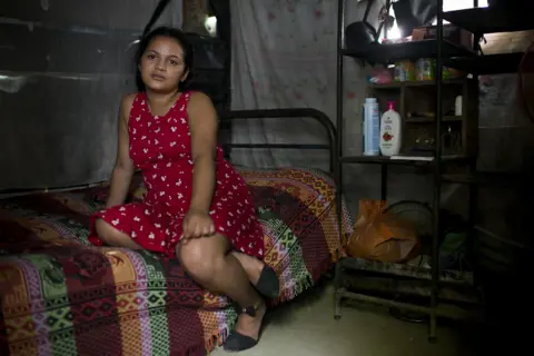 Encarni Pindado Nahín sits in the one-bedroom shack that is her home