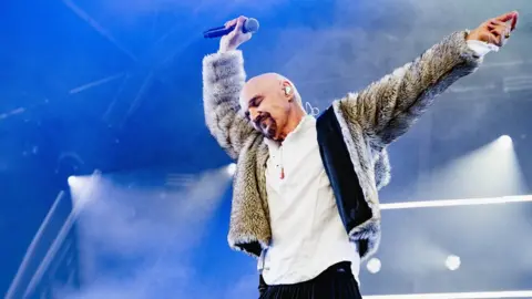 Ania Shrimpton James frontman Tim Booth dancing on stage
