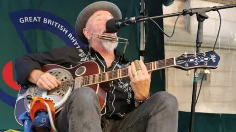 Great British Rhythm & Blues Festival Busker playing instrument at music festival