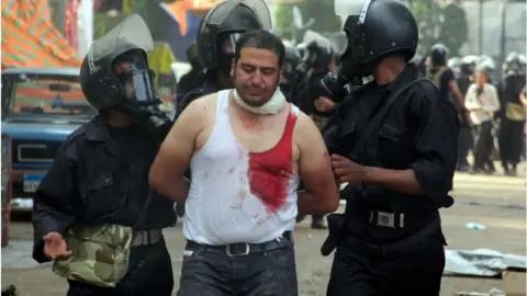 AFP Man arrested by police in Cairo (14/08/2013)