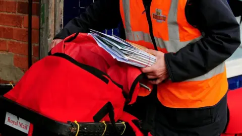 PA Media Royal Mail postal worker